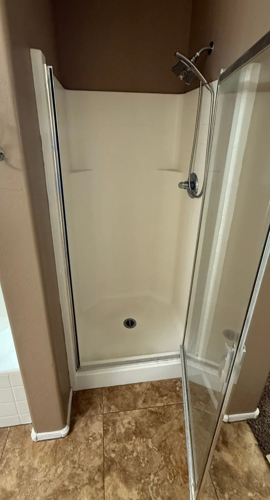 Old fiberglass shower stall before conversion to closet