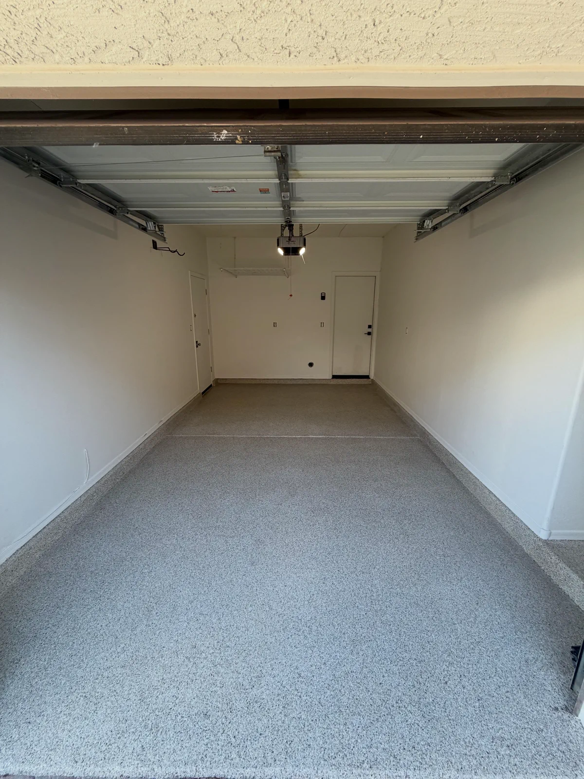 Finished garage with a light gray decorative flake floor coating